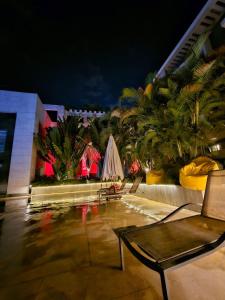 a resort patio with a table and chairs and palm trees at Sheraton Ocean 7-PRIVATE SUITES - Without Pool access in Cairo