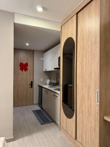 a kitchen with a red bow on the wall at Aparta studio area downtown Bogotá in Bogotá +23 photos