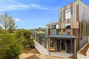 an exterior view of a building with colorful windows at Back Beach in Portsea