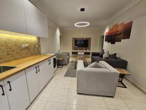 a kitchen and living room with couches and a table at Luxury Apartment A15 in Yanbu