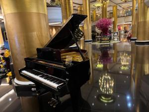 a piano in a room with a shiny floor at Large Family Groups in Air residence Makati Gym Swim Park 300 mbps in Manila