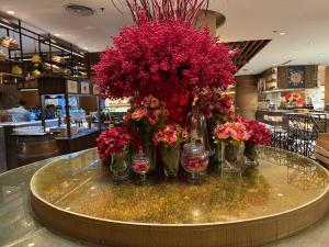 a bunch of flowers in vases on a table at Large Family Groups in Air residence Makati Gym Swim Park 300 mbps in Manila