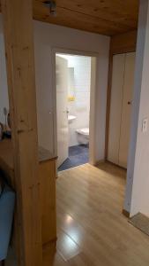 a room with a bathroom with a toilet in it at Casa14 - Swiss houses in Steffisburg
