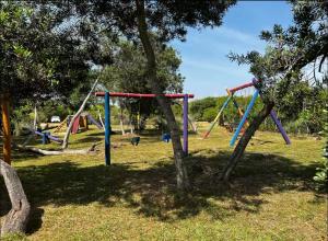 a park with a bunch of swings at CASA PARA 10 PERSONAs in Aguas Dulces