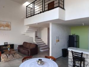 a living room with a couch and a staircase at Casa Lanre in Huichapan