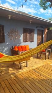 a hammock on the deck of a house at Morada Héstia in Imbé