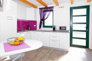 a kitchen with a bowl of fruit on a table at Family friendly house with a swimming pool Bol, Brac - 23787 in Bol