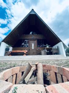 a building with a brick wall in front of it at La Encantada Cabañas in Cajamarca