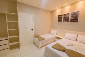 a bedroom with two beds and a closet at LOFT Bragança Apart-hotel in Bragança +25 photos