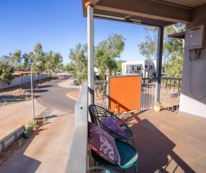 two chairs on a porch with a view of a street at Suburban Sanctuary South Hedland in South Hedland