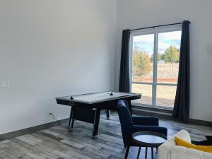 a room with a ping pong table and a couch at New Cougar Cabin with Air Hockey in Purcell +20 photos