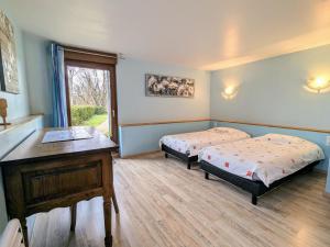 a bedroom with two beds and a desk and a window at Charmante maison rénovée avec 3 chambres, garage, et animaux admis à Gerbamont - FR-1-589-161 in Gerbamont 