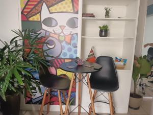 a table and two chairs in a room with plants at Espaço Van Gogh in Campinas