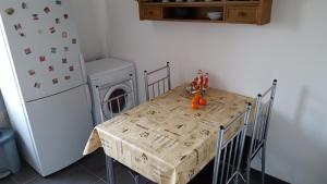 a small kitchen with a table and a refrigerator at Zimmer Müller in Wesseling