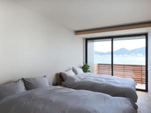 Postel nebo postele na pokoji v ubytování 壇之浦海峡Villa