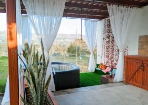 een kamer met een raam met uitzicht op de bergen bij La Cabaña de Ciela C glamping con jacuzzi , minigolf y croquet in Latacunga