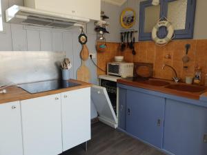 a kitchen with a sink and a counter top at Maison Vendéenne Rénovée, Proche Plage et Commerces, Chambres Indépendantes, Jardin Privé - FR-1-476-76 in La Faute-sur-Mer