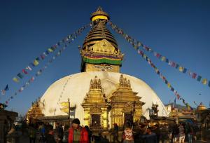 a large building with a statue on top of it at Swoyambhu Home Stay in Kathmandu