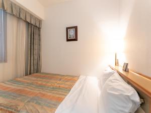 Postel nebo postele na pokoji v ubytování Tabist Hotel Mercury Asakusabashi