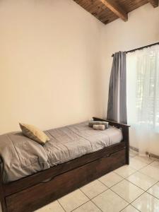 a bed with two pillows on it in a room at Dúplex céntrico en capital in Mendoza +27 photos