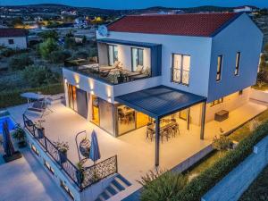 an aerial view of a house with a deck at Modern villa with private swimming pool in Vrana