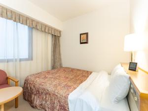 Postel nebo postele na pokoji v ubytování Tabist Hotel Mercury Asakusabashi