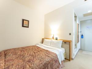 Postel nebo postele na pokoji v ubytování Tabist Hotel Mercury Asakusabashi