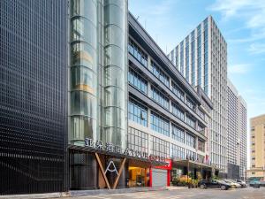 a glass building with a sign on the side of it at Atour Hotel Shenzhen Nanshan West Lizhi Valley Industrial Park in Shenzhen