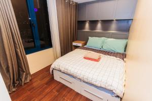 a small bedroom with a bed and a window at 2 BR Air condo Makati Penthouse SwimGym 300Netflix 5249 in Manila +64 photos