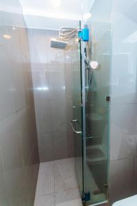 a shower with a glass door in a bathroom at 2 BR Air condo Makati Penthouse SwimGym 300Netflix 5249 in Manila