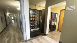 a hallway with a drink cooler in a building at Magnuson Hotel Fort Wayne North - Coliseum in Fort Wayne