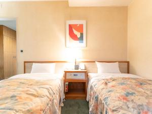 Postel nebo postele na pokoji v ubytování Tabist Hotel Mercury Asakusabashi