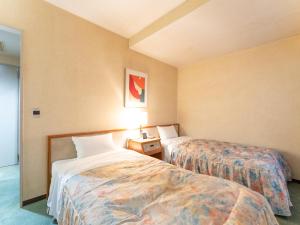 Postel nebo postele na pokoji v ubytování Tabist Hotel Mercury Asakusabashi