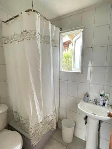 a bathroom with a shower curtain and a sink at Baguales Patagonia in Puerto Cisnes