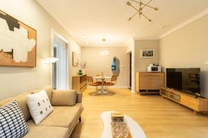 a living room with a couch and a tv at Shanghai Hills&Linghu's Transit-Prime Suite-Line 2, Huamu Rd 788, Direct to Key Spots & SNIEC in Shanghai