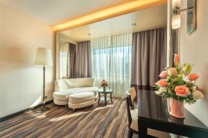 a living room with a mirror and a couch at Royal Benja Hotel - Big Room Family-Friendly in Bangkok