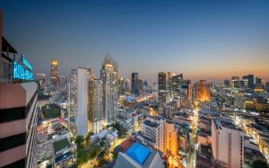 a city skyline at night with lit up buildings at Royal Benja Hotel - Big Room Family-Friendly in Bangkok