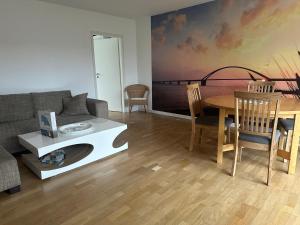 a living room with a couch and a table at Wohnung Lemkenhafen in Fehmarn +15 photos