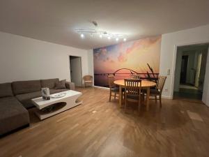 a living room with a couch and a table at Wohnung Lemkenhafen in Fehmarn