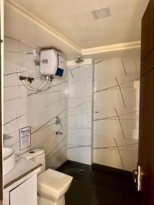 a bathroom with a shower and a white toilet at Taj Castle Homestay sutable for 17 Peoples in Agra +9 photos