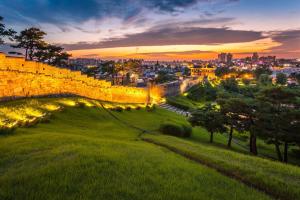 a view of the city at sunset from the city walls at Smile Home in Suwon