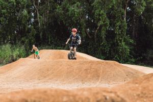 a boy riding a bike on a mound of dirt at Tasman Holiday Parks - Rollingstone in Rollingstone