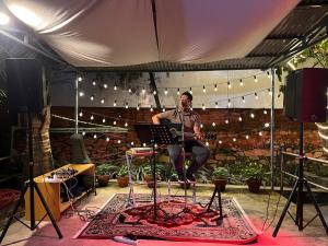 a man sitting on a drum set in a tent at Saanvi Hotel & Restaurant in Kathmandu