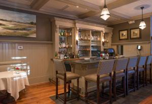 a bar in a restaurant with chairs around it at Wentworth Mansion in Charleston +19 photos