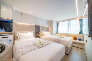 Ένα ή περισσότερα κρεβάτια σε δωμάτιο στο Yunbo Hotel