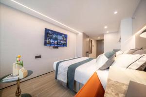 Ένα ή περισσότερα κρεβάτια σε δωμάτιο στο Yunbo Hotel