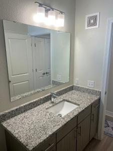 a bathroom with a sink and a large mirror at Chic 1BHK Haven Quiet & Relaxing Near Austin in Cedar Park +11 photos