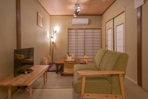 a living room with a chair and a table at -鳴間の宿 Narumanoyado- Kyoto Aquarium-MUS in Kyoto