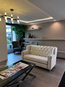 a living room with a couch and a table at Spacious Sukhumvit Condo near EmQuartier in Bangkok