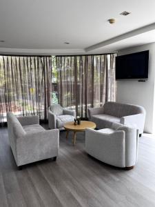 a living room with two couches and a tv at Spacious Sukhumvit Condo near EmQuartier in Bangkok